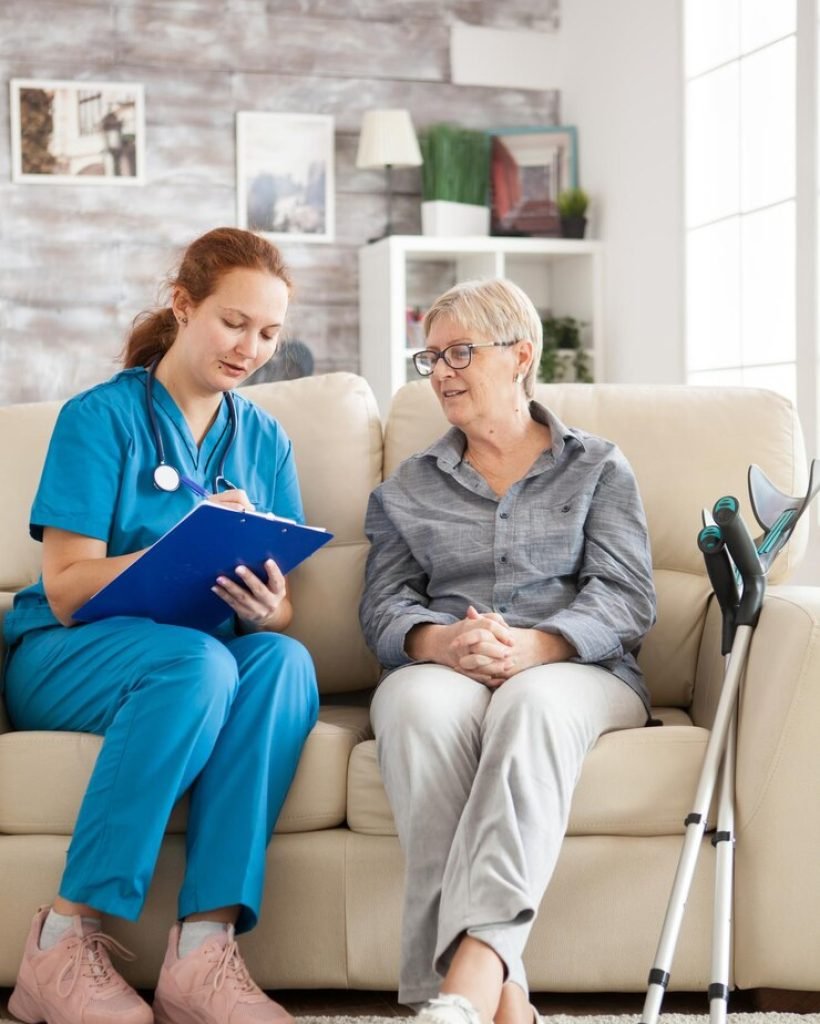 female-doctor-with-senior-woman-sitting-couch-nursing-home-writing-prescription-clipboard_482257-45168